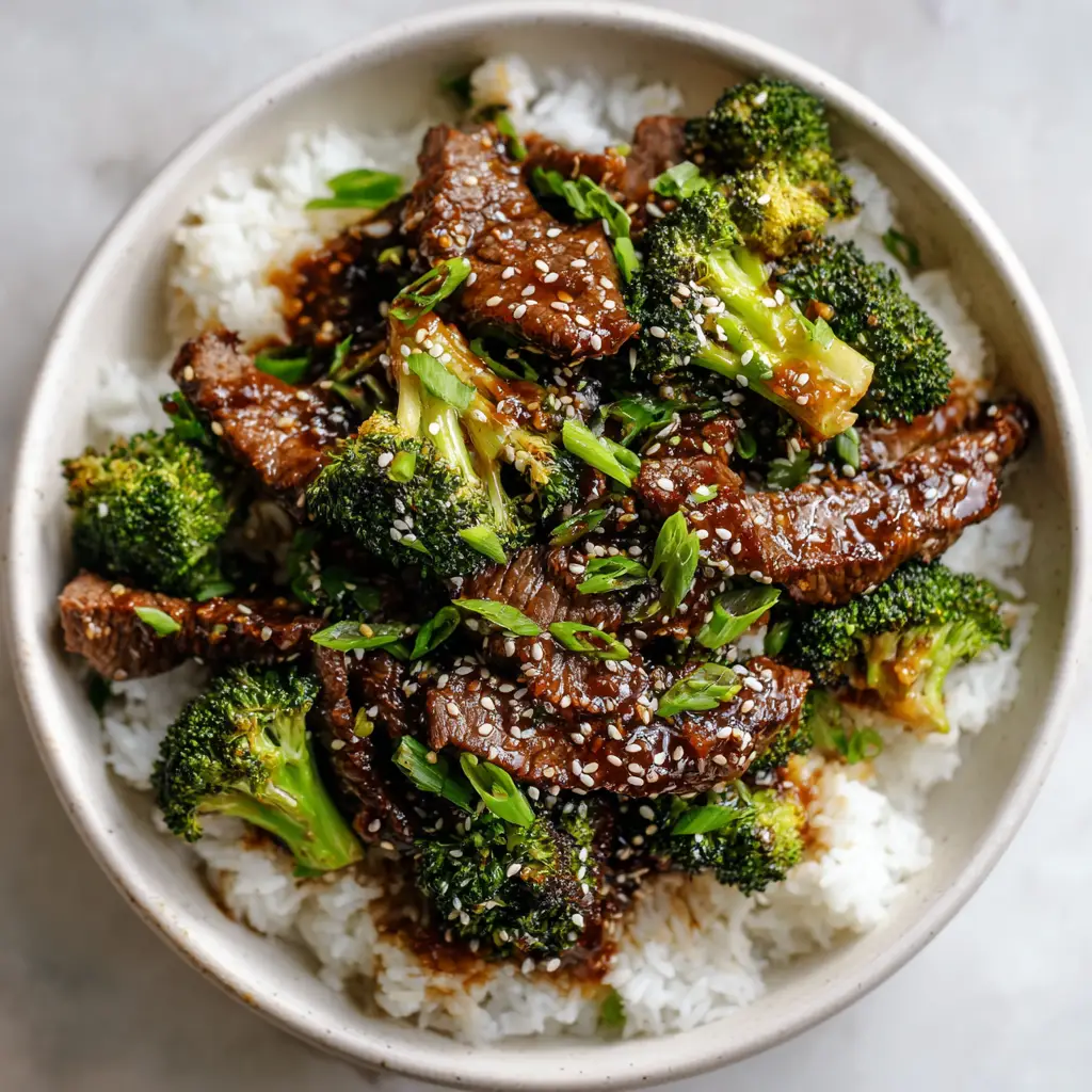 A smartphone shot showing the rich, charred crust on seared flank steak mixed with sesame seeds and scallions.