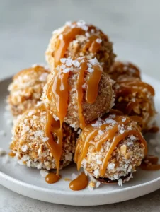 Handheld smartphone photo of Salted Caramel Pretzel Cheesecake Bites showing the amber caramel zig-zag drizzle.