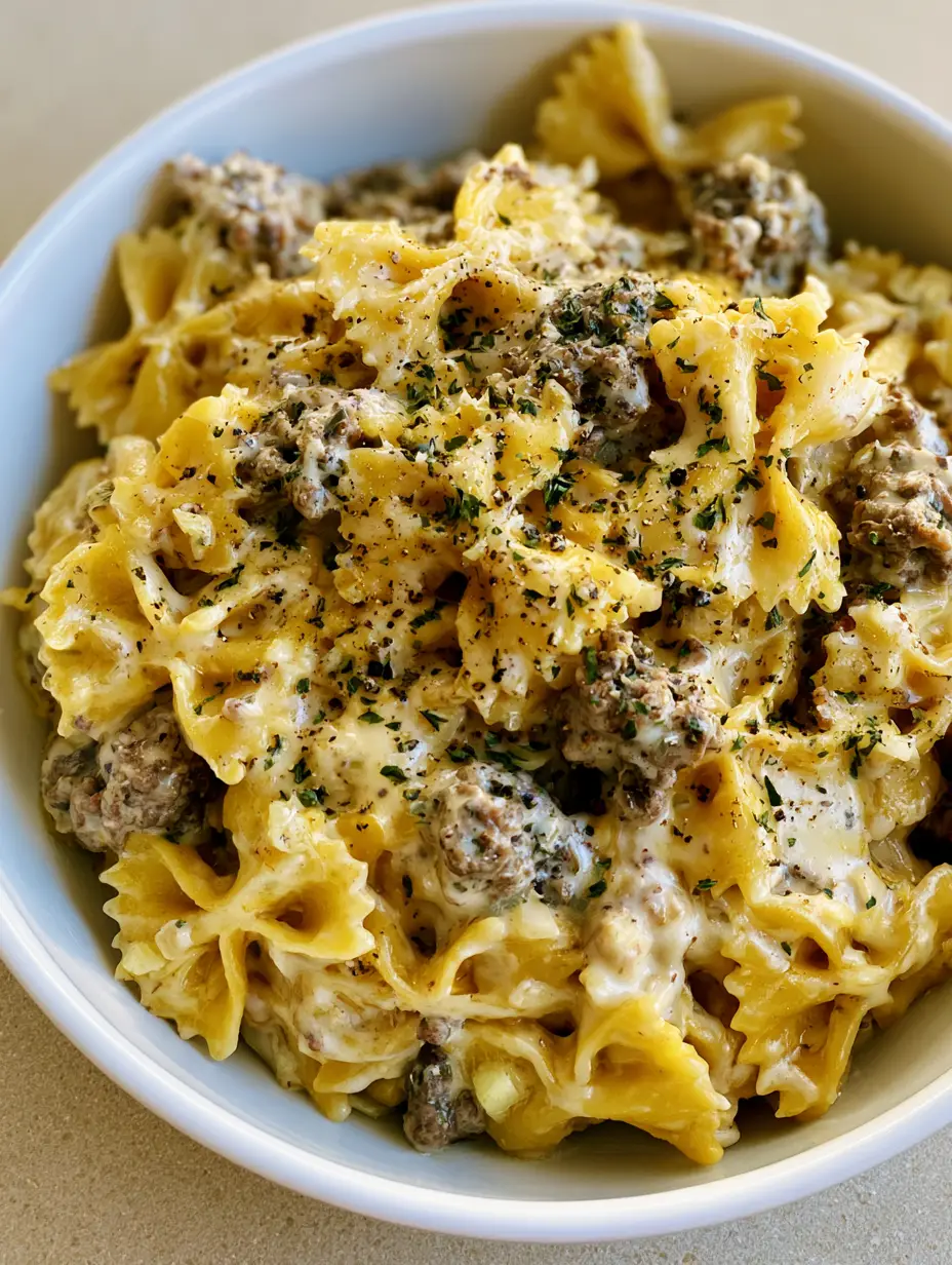 Creamy Beef Bowtie Pasta with Garlic Parmesan Cream Sauce 3 Overhead view of Creamy Beef Bowtie Pasta featuring al dente bowtie pasta and savory ground beef.