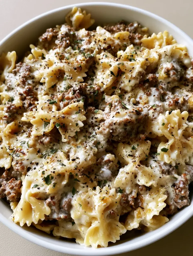 Creamy Beef Bowtie Pasta with Garlic Parmesan Cream Sauce 1 Close-up detail of the thick, velvety garlic parmesan sauce on bowtie pasta and beef.