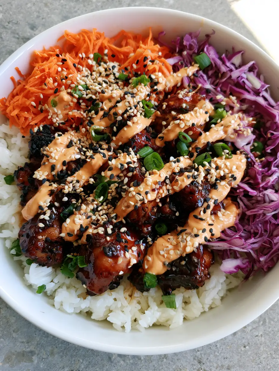 Close-up of seared mahogany chicken pieces in a white ceramic bowl. (Korean BBQ Chicken Bowls)
