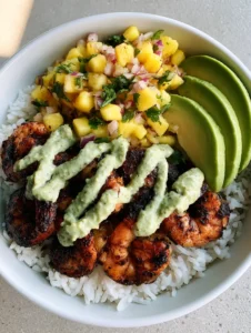A handheld smartphone photo of a Shrimp Rice Bowl with Pineapple Salsa in a white bowl showing charred shrimp and bright fruit salsa.