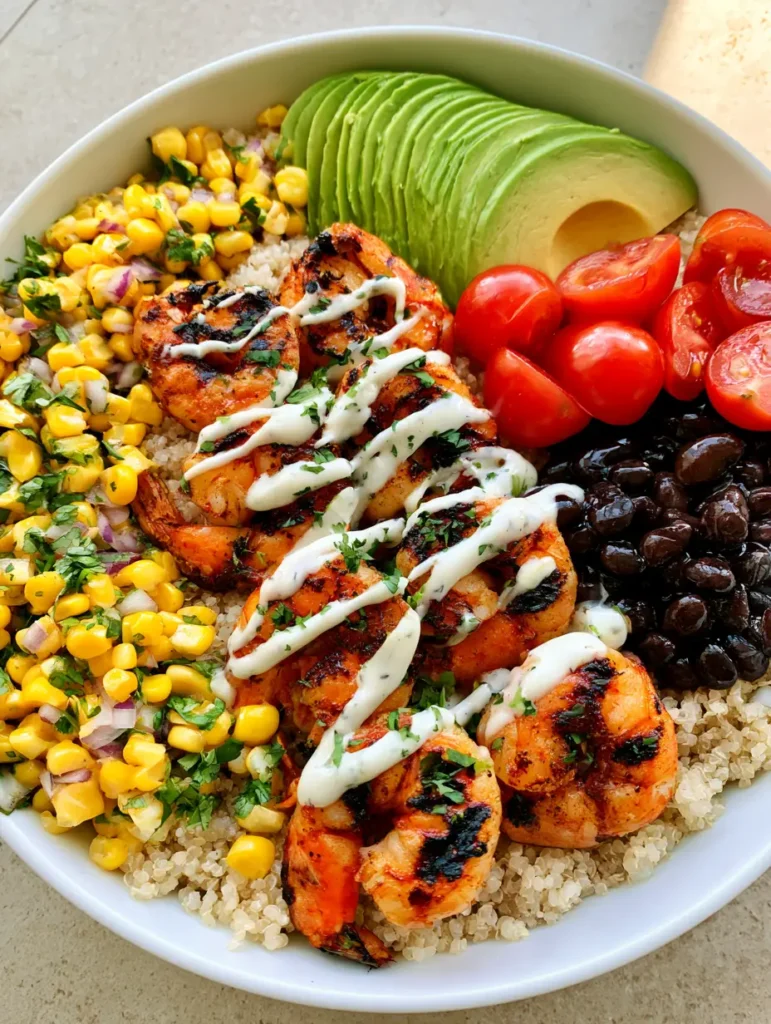 Healthy Grilled Shrimp Bowl with Garlic Cream Drizzle 2 Meticulously layered Healthy Grilled Shrimp Bowl with dark charred grill marks on the shrimp and bright yellow corn kernels.